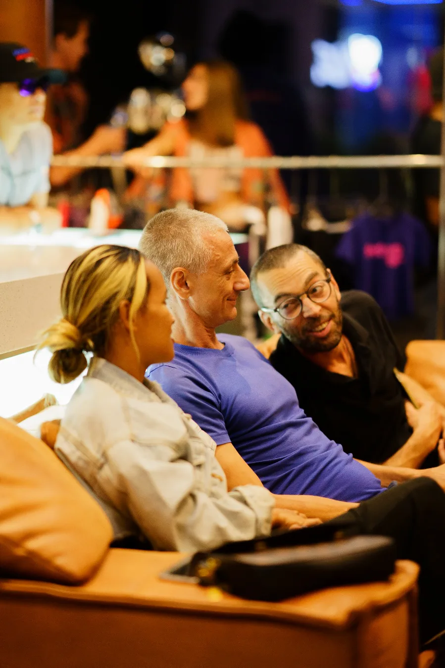 Three attendees converse while seated together at the Cannabox event.