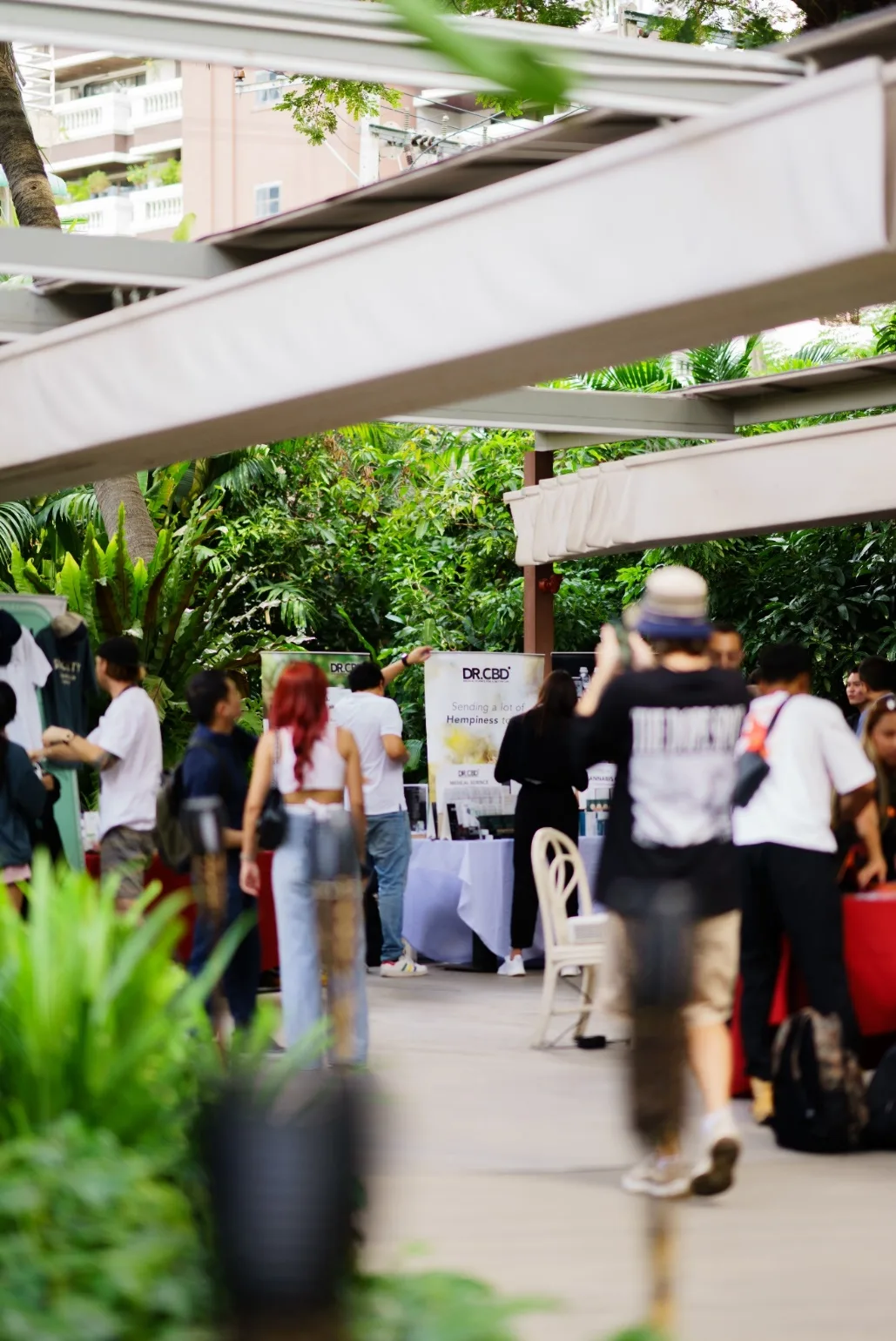 Attendees arrive along the leafy entrance path at MonkeyPod.