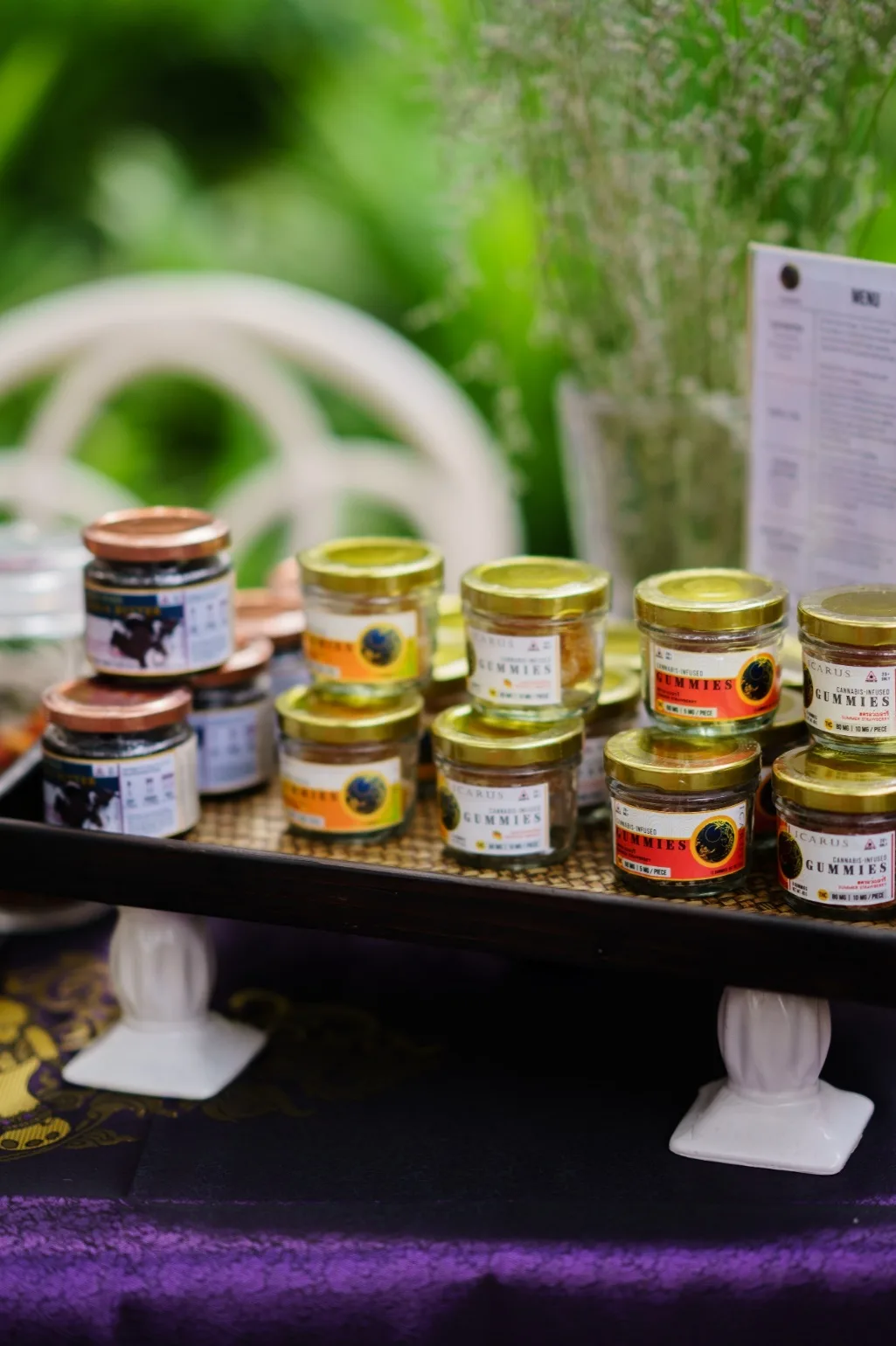 Jars of miniature gummies are displayed on a sponsor table.