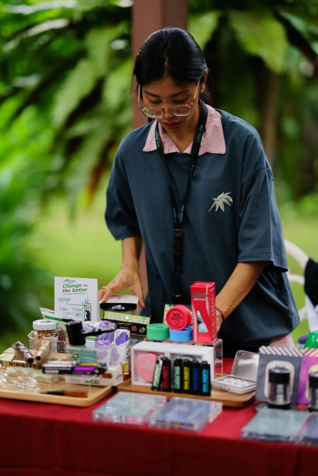 A High Society representative arranges products at a booth.