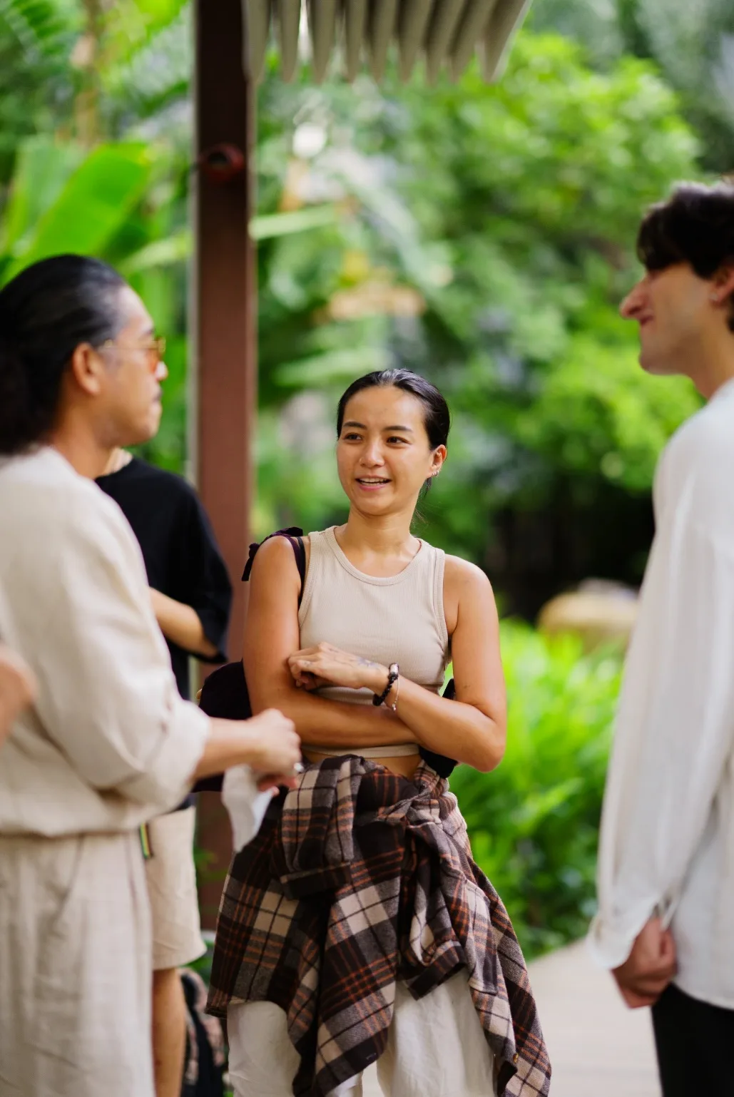 Cenk Cetin talks with two event planners in the garden.
