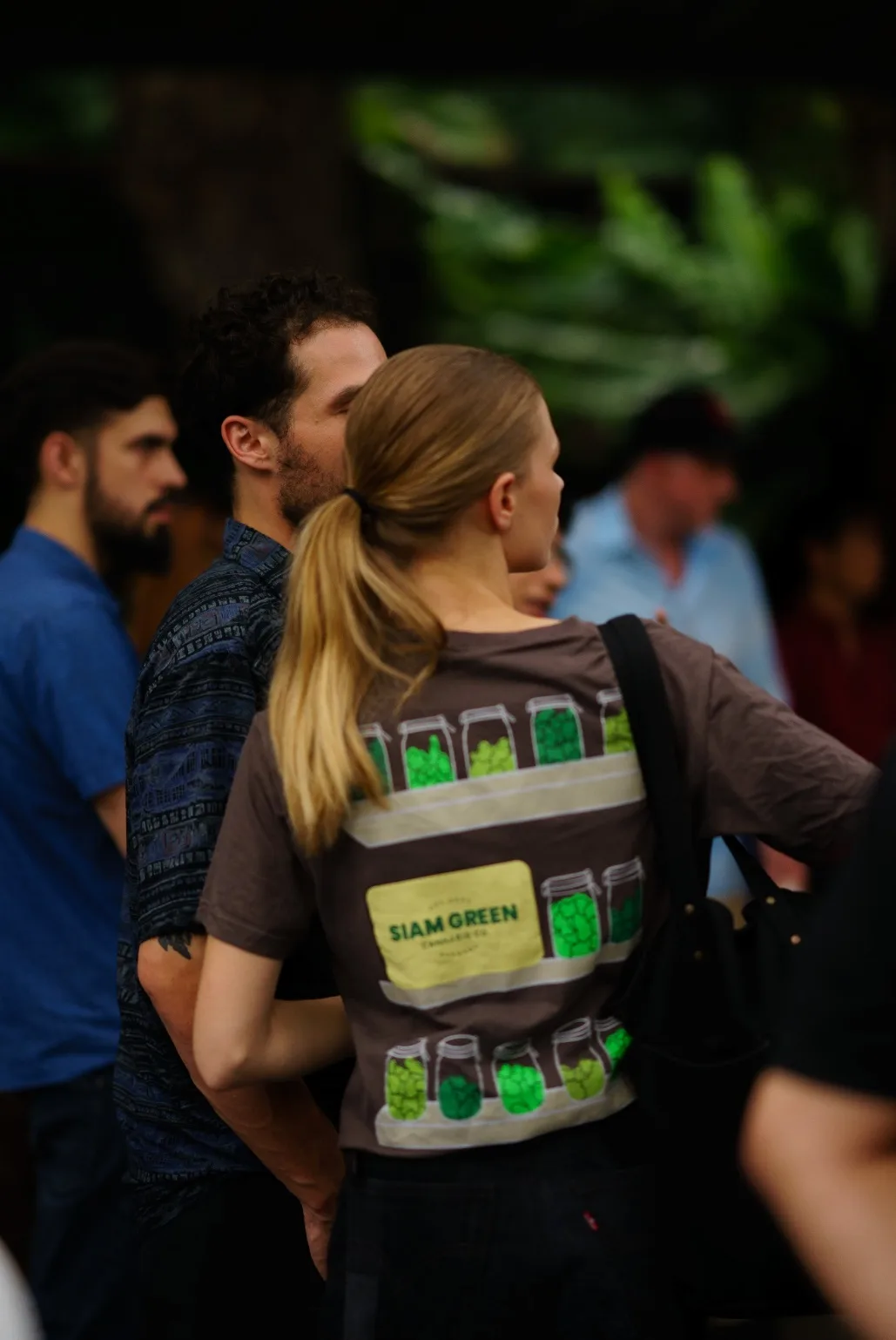 An attendee wears a Siam Green Cannabis Co. shirt.