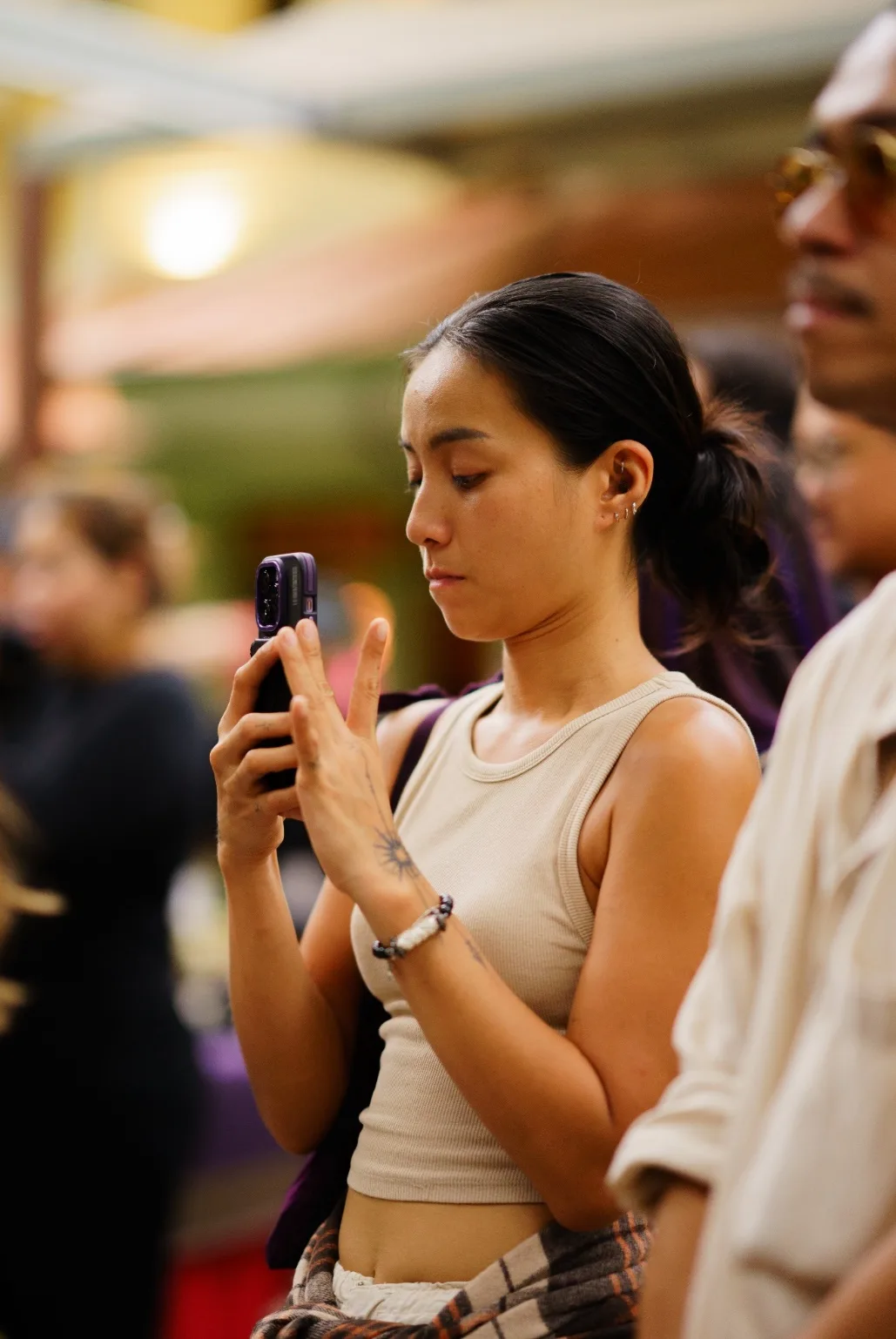 An event planner records the workshop on her phone.