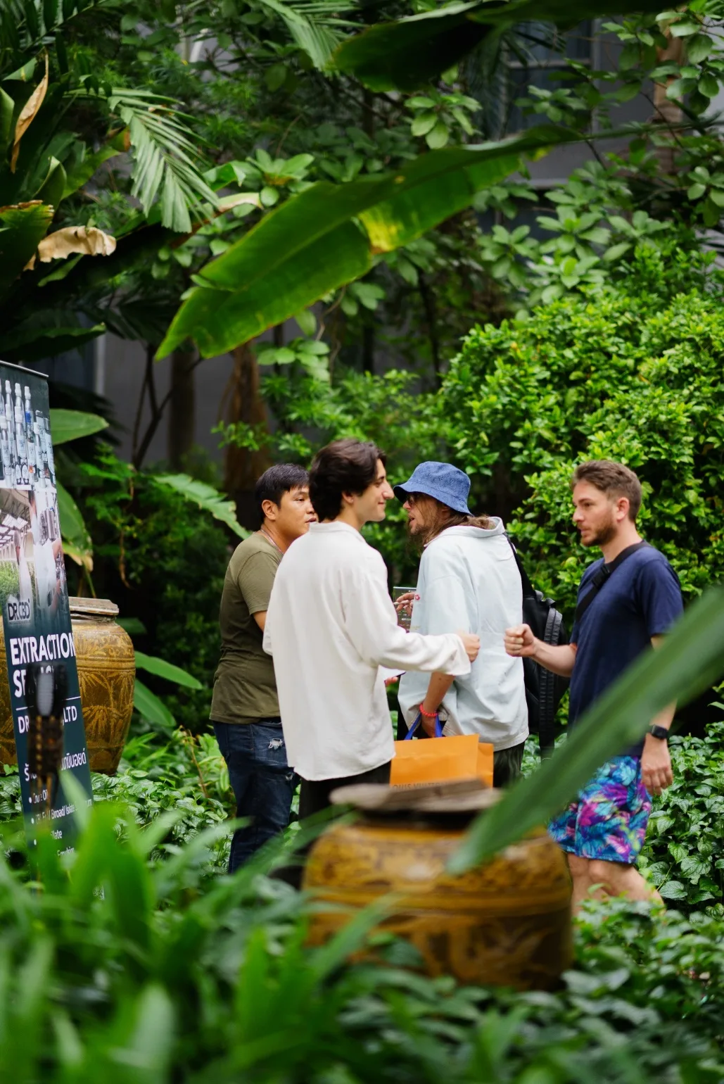 Event hosts welcome guests at the leafy MonkeyPod entrance.