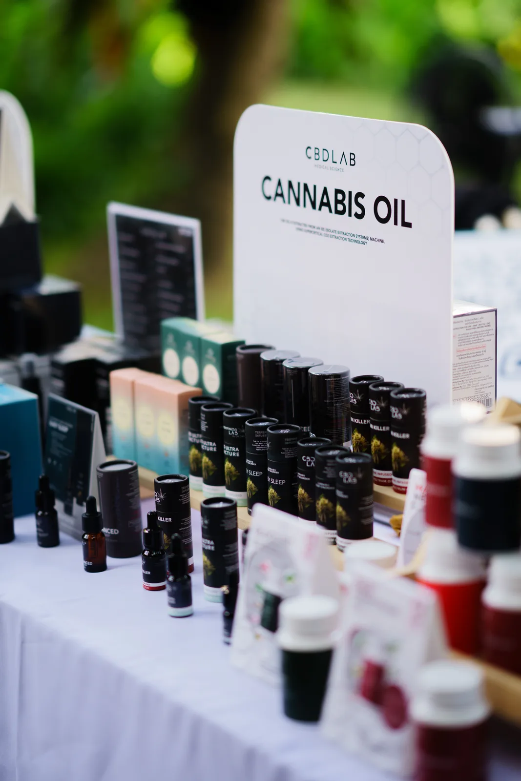 Cannabis oils and packaged products are displayed on the DR CBD table.