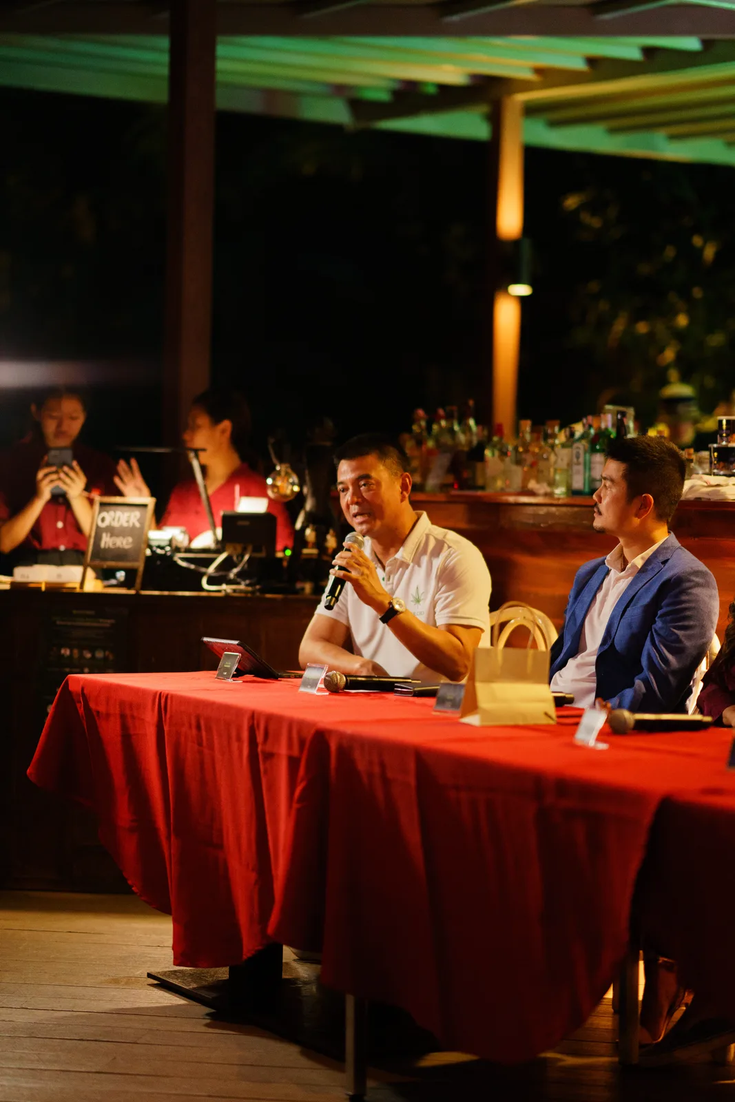 Pornchai Padmindra speaks while seated at the panel table.