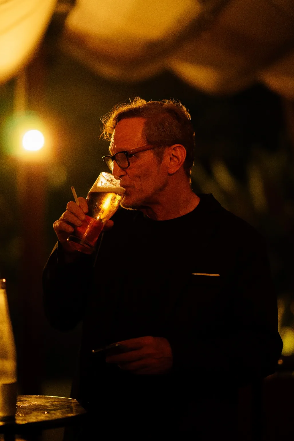 An attendee enjoys a drink inside MonkeyPod at the end of the event.